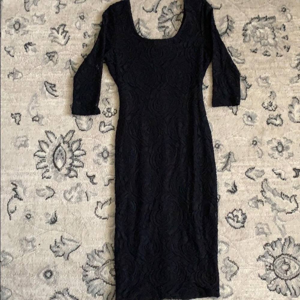 Black, mid length, tight fitting dress